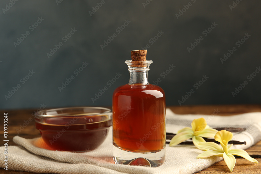 Aromatic homemade vanilla extract on wooden table Aromatic homemade vanilla extract on wooden table
