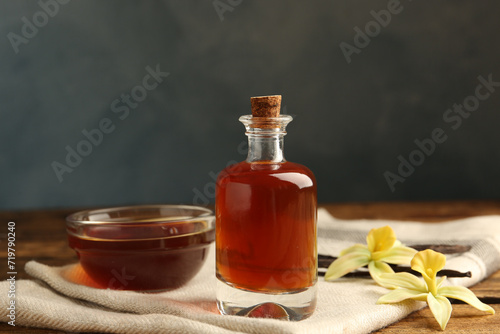 Fototapeta Naklejka Na Ścianę i Meble -  Aromatic homemade vanilla extract on wooden table
