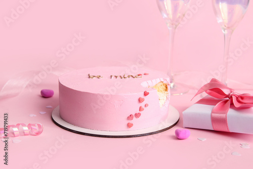 Bitten bento cake with gift box on pink background. Valentine's Day celebration