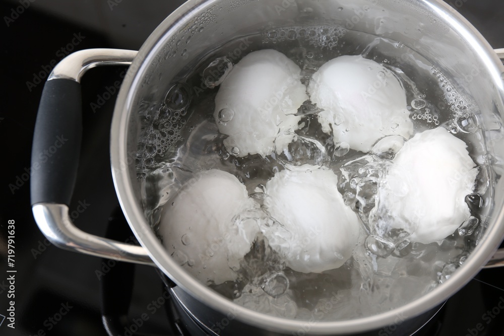 Chicken eggs boiling in pot on electric stove, above view Chicken eggs boiling in pot on electric stove, above view