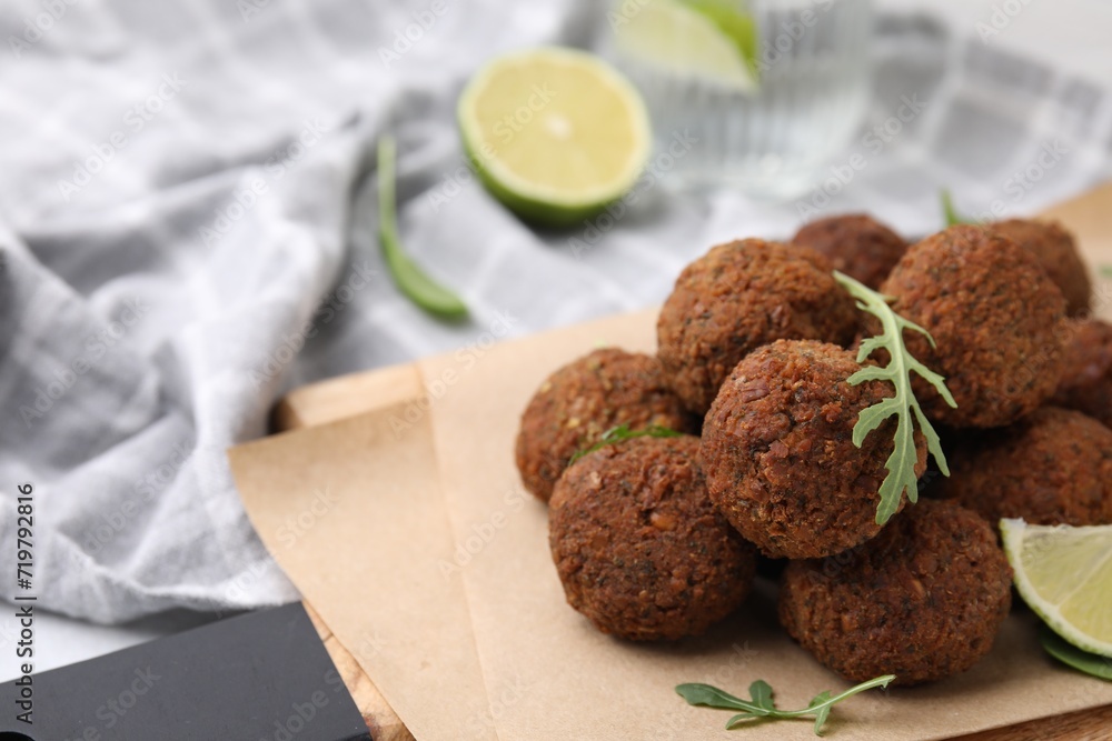 Delicious falafel balls and arugula on table, closeup. Space for text Delicious falafel balls and arugula on table, closeup. Space for text