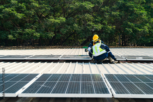 Worker Technicians are working to construct solar panels system on roof. Installing solar photovoltaic panel system. Men technicians carrying photovoltaic solar modules on roof. © ultramansk