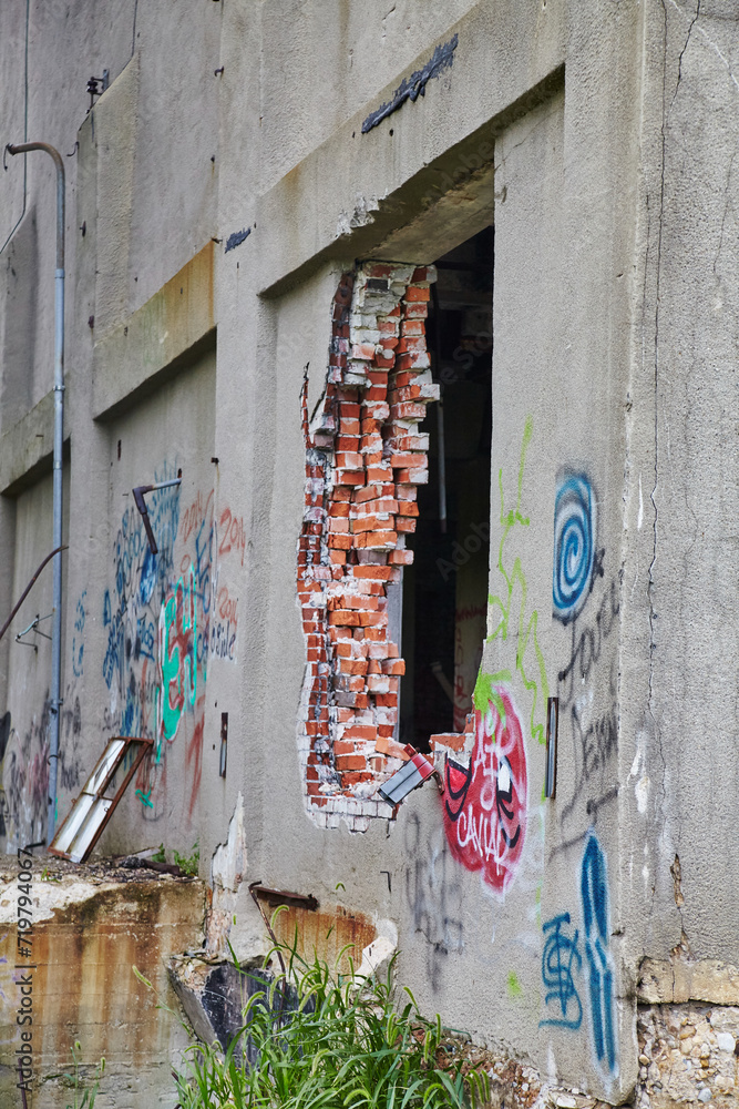 Graffiti on Abandoned Grain Elevator Walls with Urban Decay, Eye-Level View