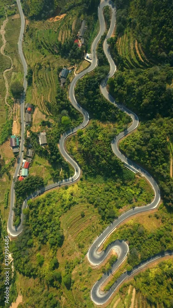 Top view of scenic winding road in the mountains on the Ha Giang Loop, North Vietnam. Top view of scenic winding road in the mountains on the Ha Giang Loop, North Vietnam.