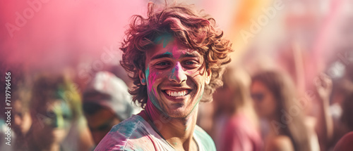 Celebrating a Holi festival with a man with his face covered in colorful paint showing his happiness photo