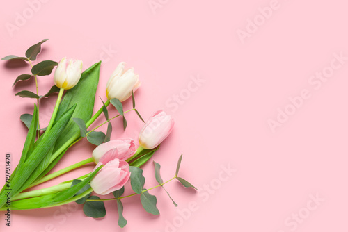 Fototapeta Naklejka Na Ścianę i Meble -  Beautiful tulips with eucalyptus on pink background. International Women's Day