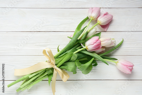 Bouquet of beautiful tulips on white wooden background. International Women s Day