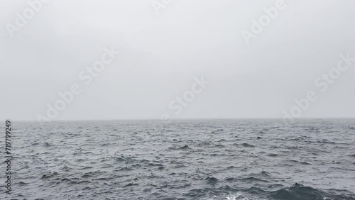a rough weather ocean sea waves stormy sky cloudy spray powerful strong outdoors video motion wet tropical hurricane water clouds wind breaking raining wave splashing climate rain storm natural surge