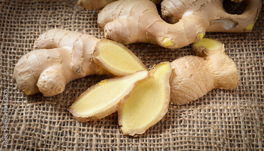 Ginger root sliced on sack background. sun dried and cutting out Ginger root sliced on sack background. sun dried and cutting out