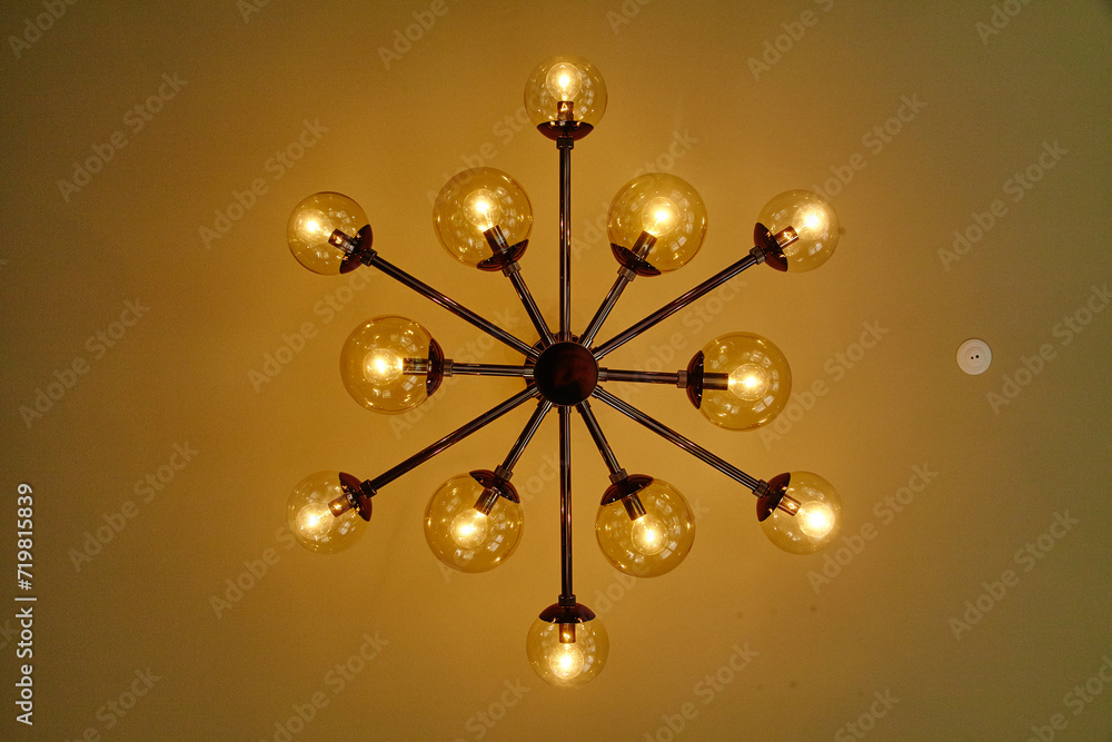 Obraz premium Modern Industrial Chandelier with Vintage Bulbs, Warm Glow, Upward View