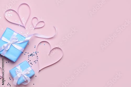 Composition with gift boxes and paper hearts for Valentine's Day celebration on beige background