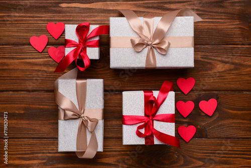 Composition with different gift boxes and hearts for Valentine's Day celebration on wooden background