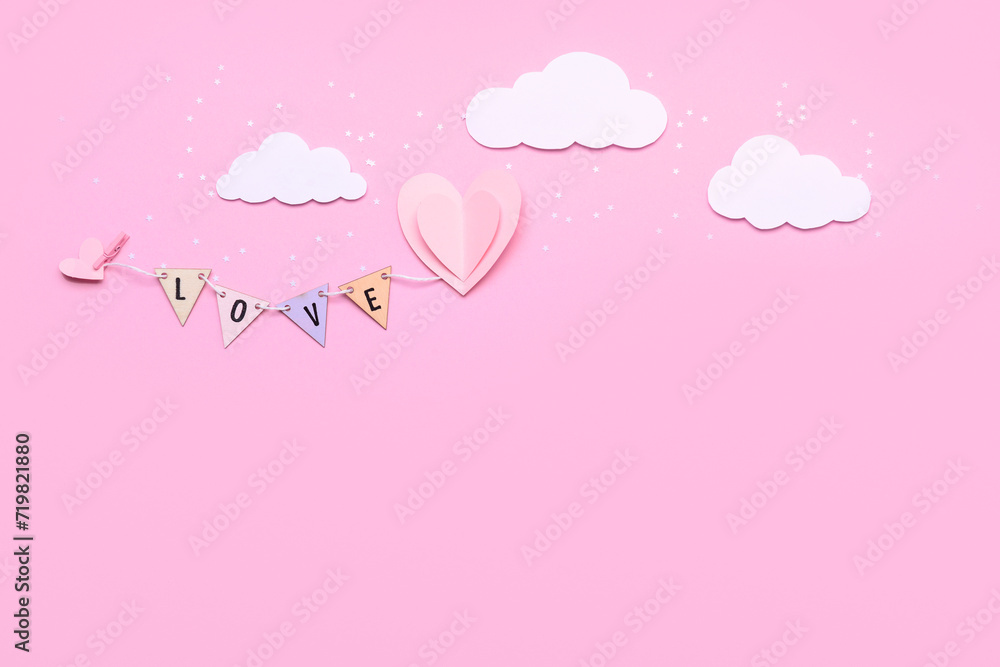 Composition with word LOVE and paper decor for Valentine's Day celebration on pink background