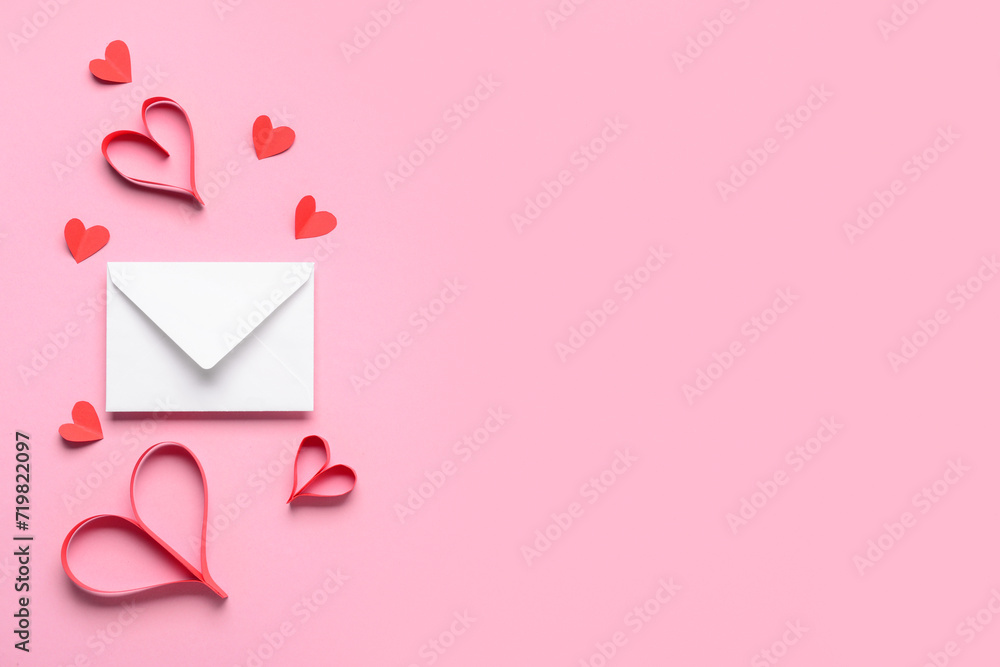 Composition with paper hearts and envelope for Valentine's Day celebration on pink background