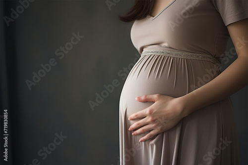 お腹に手を置いている妊婦 photo