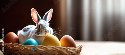 basket inside which sits a gray rabbit and contains Easter eggs with free space for text. Easter, spring