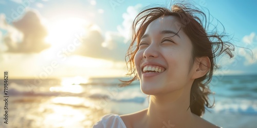 Happy and beautiful young woman is smiling at the beachside, delightfully enjoying a sunny day. Capture the essence of her healthy lifestyle and laughter out