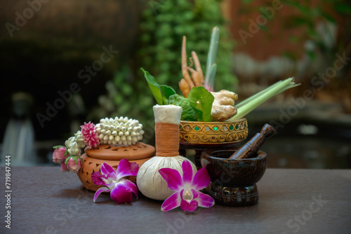 Spa massage wellness decorations setting on wood table. Thai spa massage traditional compress for hot massage and spa relaxing treatment of office syndrome. Massage for health concept.