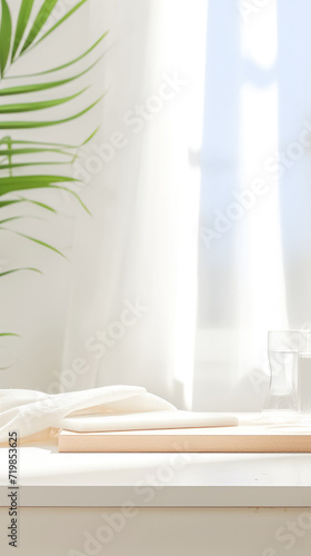 background consisting of a green fern leaf  a white board on the table  a vessel with a white liquid  against the backdrop of an open window and blue sky. Delicate tones