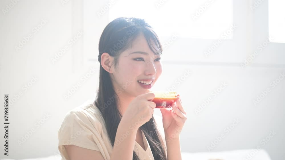 Asian (Japanese) woman with long hair relaxing in room Drinking tea Asian (Japanese) woman with long hair relaxing in room Drinking tea