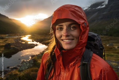 Portrait of a smiling female hiker looking at camera in mountains © Cuong