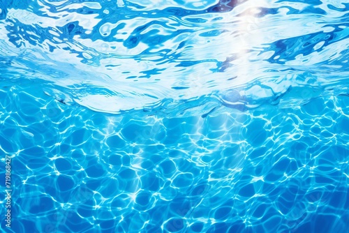 Swimming pool rippled water background with sun reflections, close up