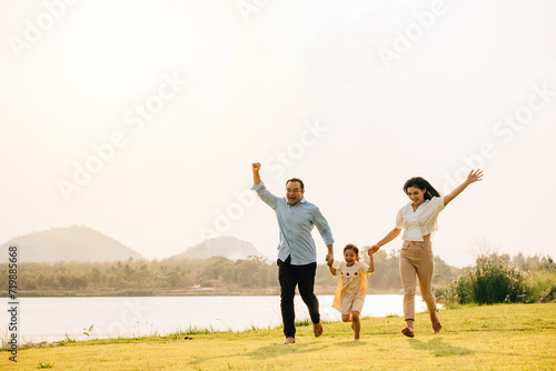 Happy family running through a beautiful green field on a sunny summer day, enjoying the freedom and beauty of nature together, Happy Family Day Concept