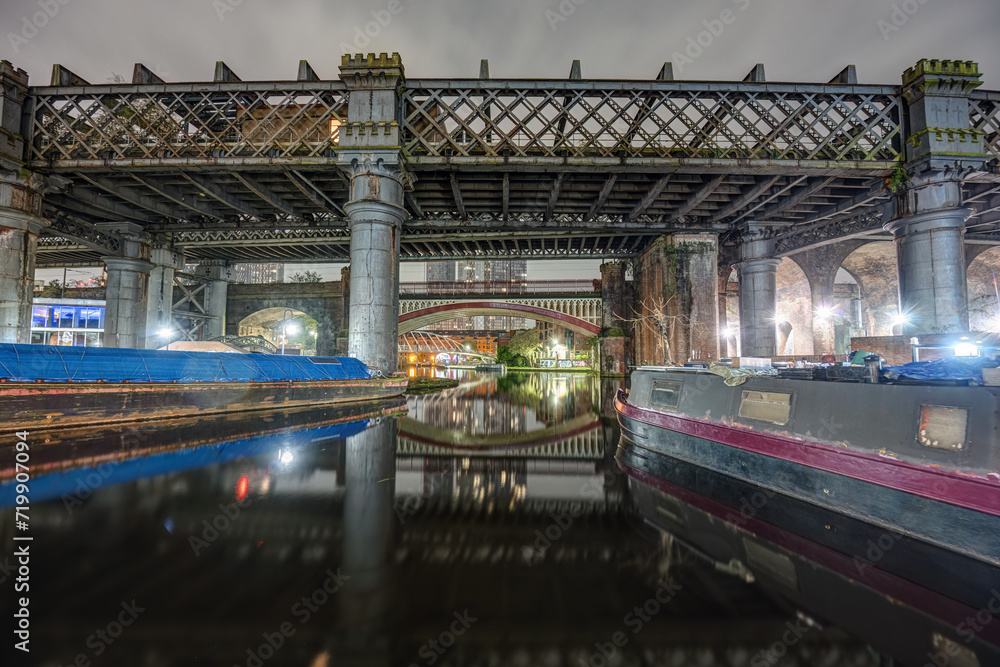 The old Castlefield viaduct and one of the canals in Manchester at night The old Castlefield viaduct and one of the canals in Manchester at night