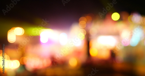 Colorful Bokeh abstract blurred background music festival stage show performance party. Vibrant bokeh background spark animate motion. Backdrop display with twinkling night life shape blinking light © aFotostock
