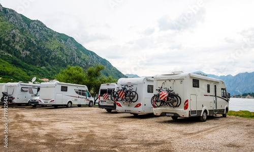 Group of motorhome vans parked at coast with sea view. Kotor bay, Montenegro