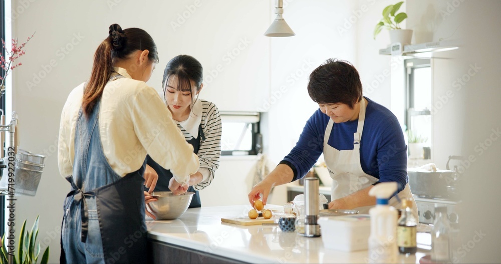 Obraz premium Japan, women and cooking in kitchen with teaching for recipe, Japanese cuisine and healthy meal in restaurant. Chef, people and traditional lunch with learning or preparation for dinner and culture