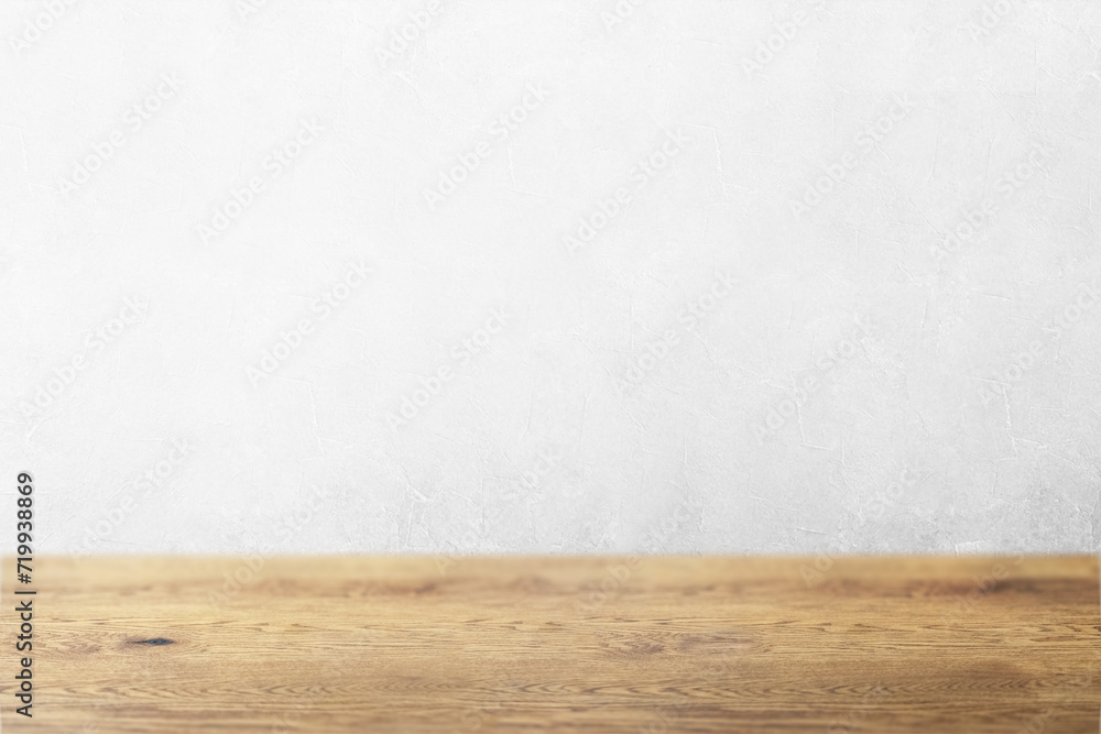 木目のあるナチュラルな木のテーブルと凹凸のある白の壁の背景