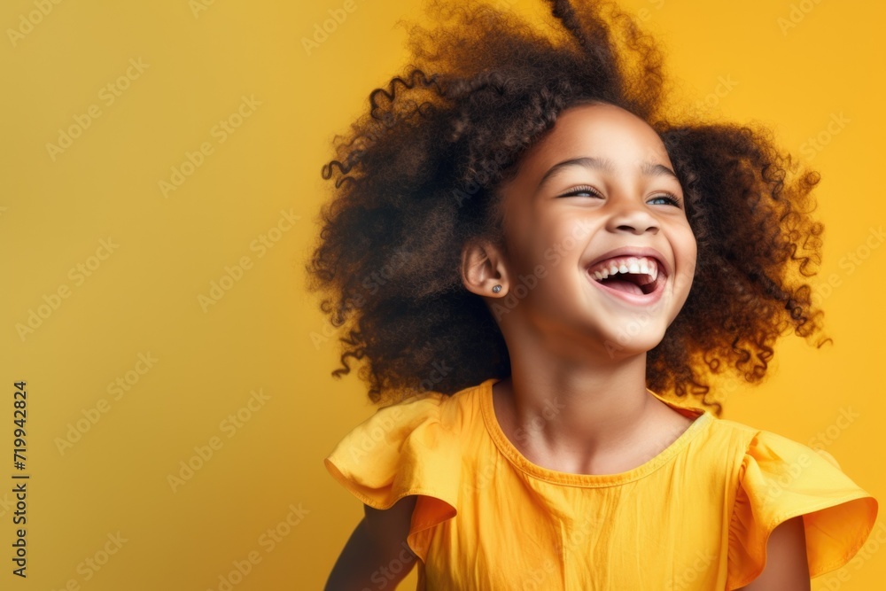 A joyful little girl with a big smile on her face. This picture can be used to portray happiness, joy, and innocence A joyful little girl with a big smile on her face. This picture can be used to portray happiness, joy, and innocence