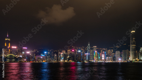 Panorama of Hong Kong City skyline with tourist at night. View from across Victoria Harbor HongKong.