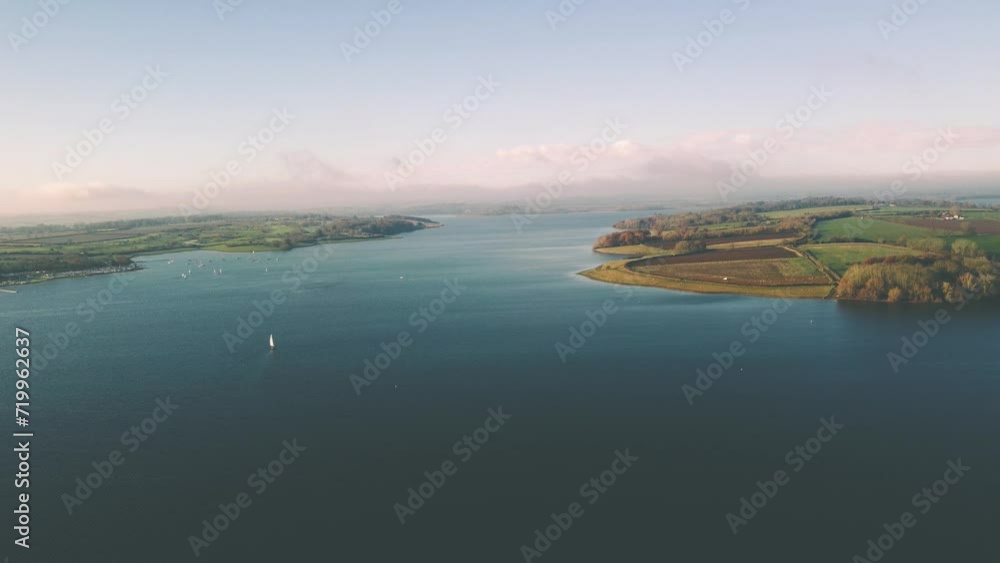 Aerial view 4k birds eye view of Rutland water in Rutland England UK. Clear blue skies on a cold day with clear waters and water fowl. Aerial view 4k birds eye view of Rutland water in Rutland England UK. Clear blue skies on a cold day with clear waters and water fowl.