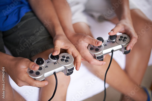 Children, hands and video game controller in a house for gaming, subscription or entertainment closeup from above. Gamepad, zoom and gamer boy kids at home with esports, competition or challenge