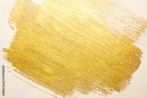gold paint splatter on a white background