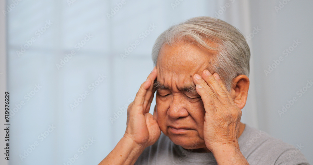 Asian old man with migraine headache. Elderly man suffering from a headache. Asian old man with migraine headache. Elderly man suffering from a headache.