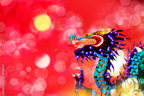 Traditional chinese dragon on festive blur bokeh background. Statuette of dragon, New Year symbol