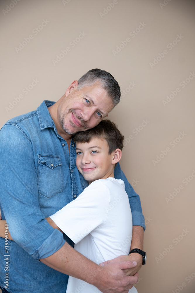 father and son are posing in front of brown background, love, family, teenager father and son are posing in front of brown background, love, family, teenager