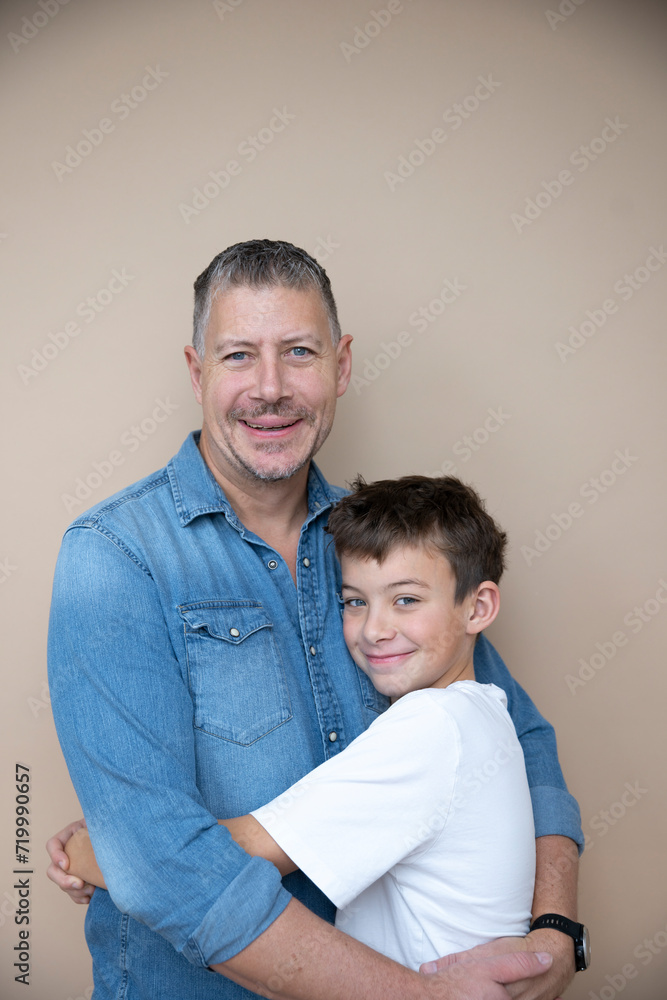 father and son are posing in front of brown background, love, family, teenager father and son are posing in front of brown background, love, family, teenager