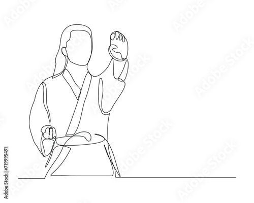 Continuous single line sketch drawing of young woman confident karateka in kimono practicing karate combat. One line traditional martial art sport training concept Vector illustration
