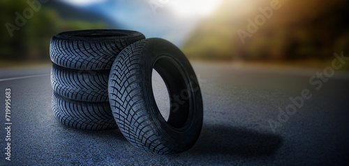 Four summer tire on road. Change tyre. 4 wheel off on nature in blurred background. Advertise banner with copy space.