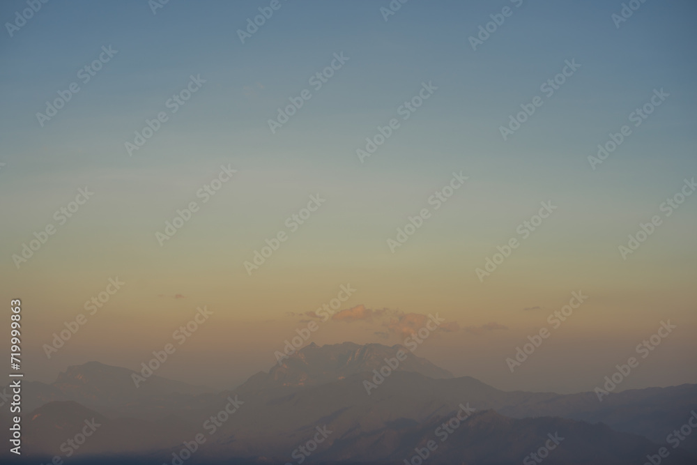 travel and people activity concept with twilight sky before sunset with layer of mountain