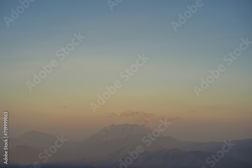 travel and people activity concept with twilight sky before sunset with layer of mountain