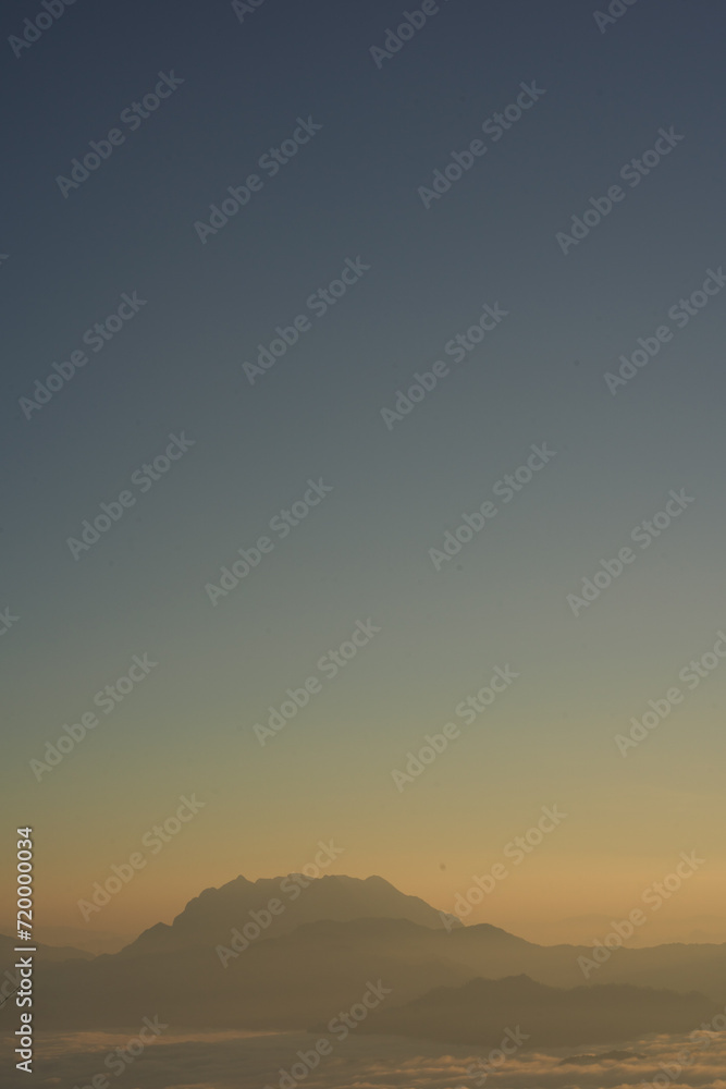 travel and people activity concept with twilight sky before sunrise with mountain and fog on foreground