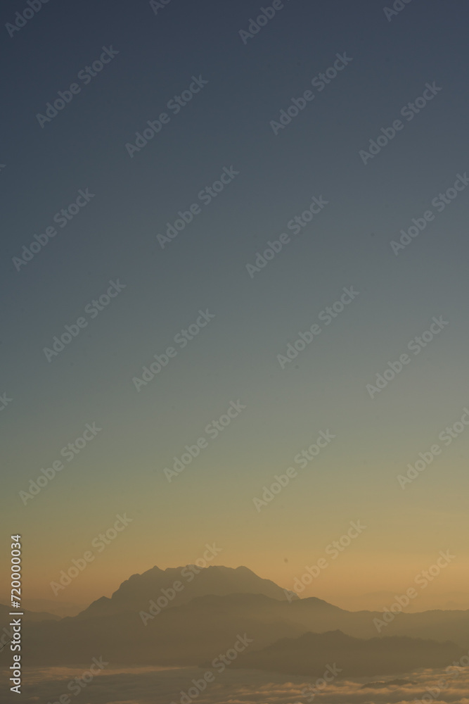 travel and people activity concept with twilight sky before sunrise with mountain and fog on foreground travel and people activity concept with twilight sky before sunrise with mountain and fog on foreground