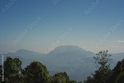 travel and people activity concept with twilight sky before sunrise with mountain and fog on foreground