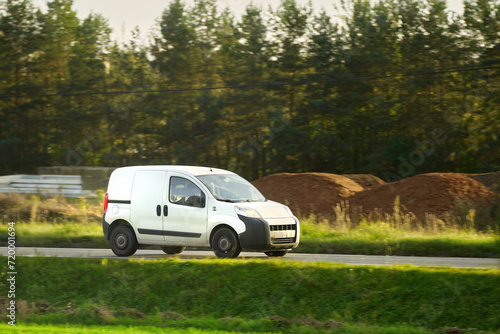 delivery van. A mockup of a white commercial vehicle isolated on the road. Perfect for your business and shipping needs.