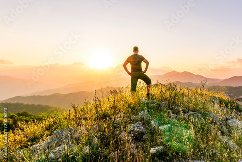 man doing hiking sport in mountains with anazing highland view photo